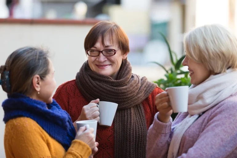 old ladies drinking tea on a white cup