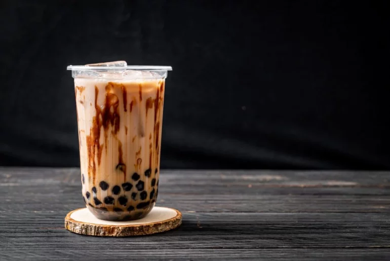 Brown Sugar Milk tea on a table with black background