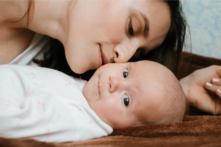 A woman smelling her baby's face