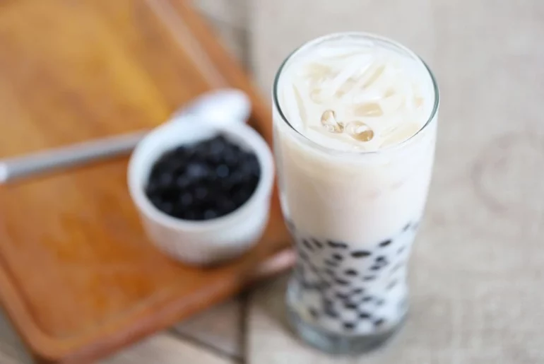 Oolong Milk tea with pearls on a wood board