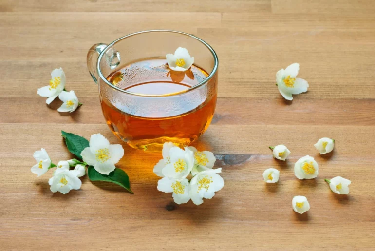 jasmine tea with jasmine flowers on top of the table