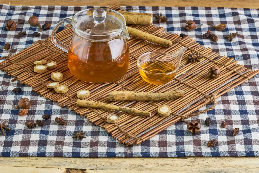 A pot and cup of tea on a wooden placemat