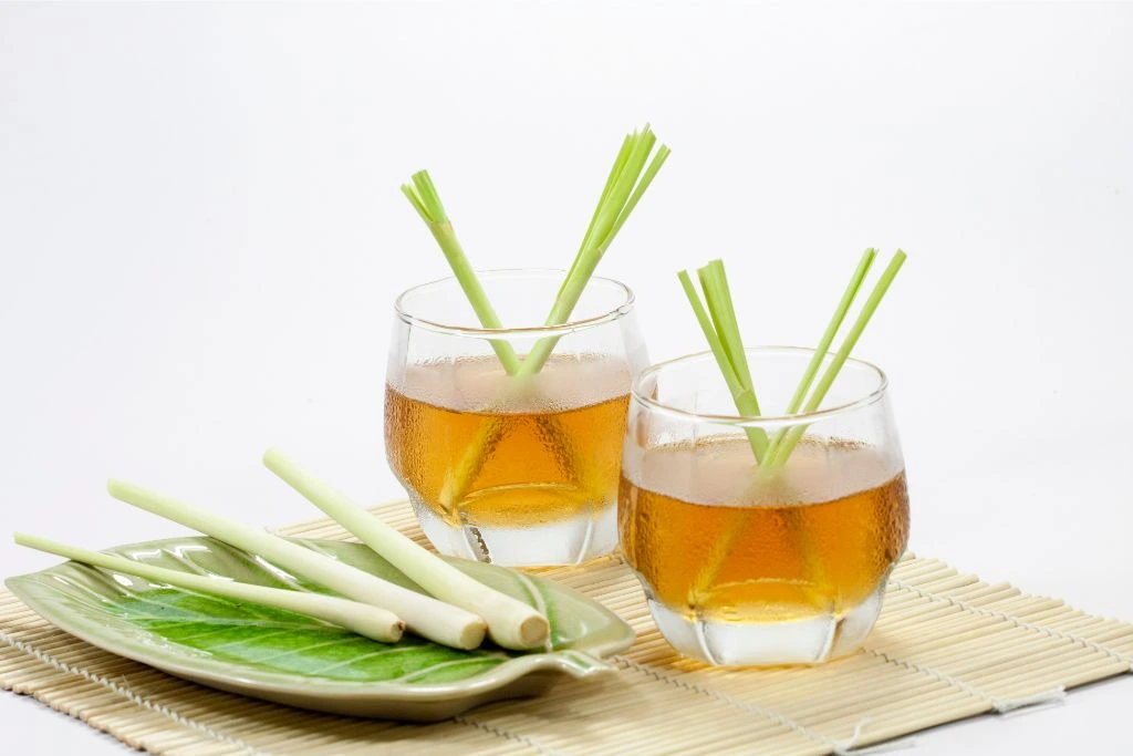 Two cups of lemongrass tea on a wooden placemat