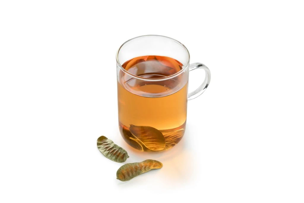 A cup of Senna Tea on a white background