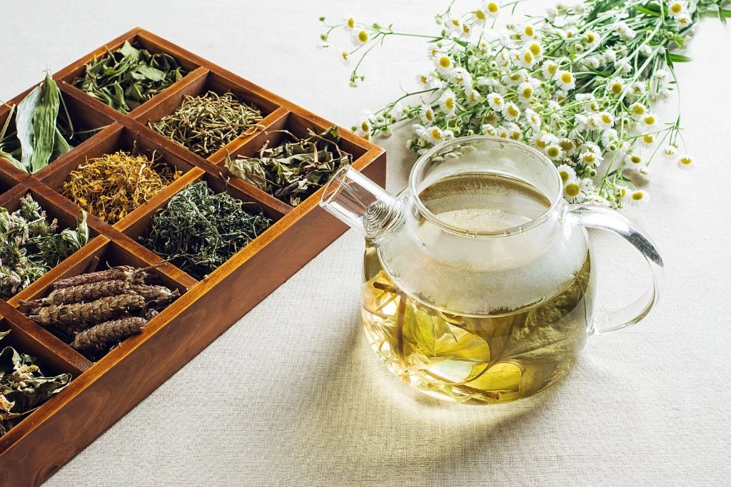 dried leaves on a box together with transparent teapot