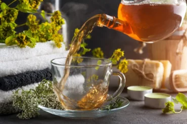 Pouring tea on a cup