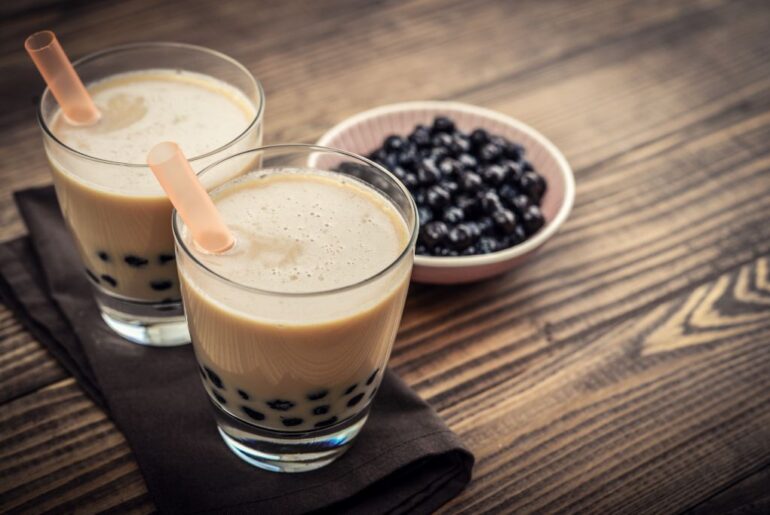 A milk tea in a glass of cups with tapioca pearls