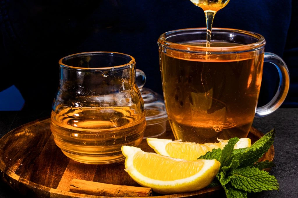 two jar glasses of honey and lemon tea
