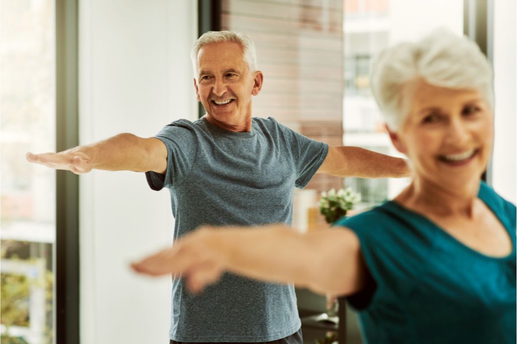 two elderly having a regular exercise to reduces the risk of chronic diseases