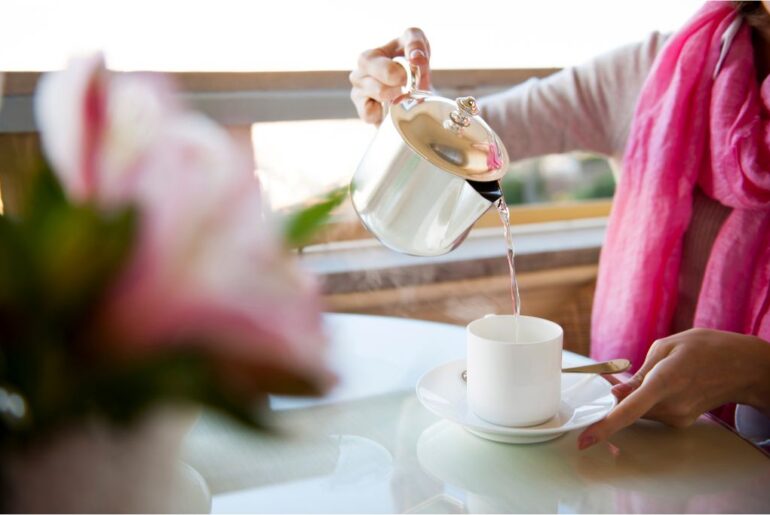 a girl pouring a tea to a cup