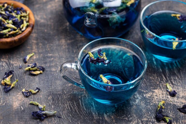 a cup of blue lotus tea with dry flowers of blue lotus