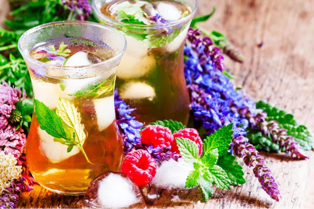 herbal iced tea with raspberries and ice in islamic glasses