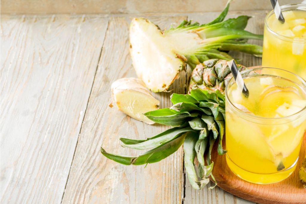 Pineapple tea with straw and pineapple fruit as decorations