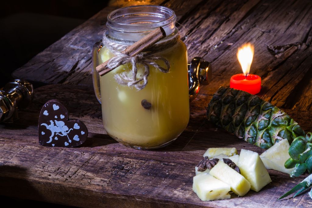 Pineapple Green tea with chunks of pineapple placed in a wooden table 
