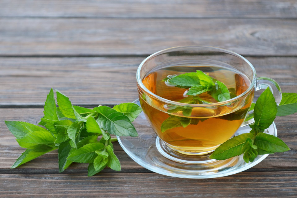 cup of Peppermint Tea with peppermint leaves 