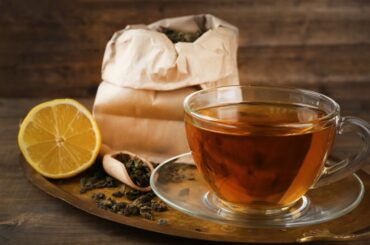 black tea with lemon beside a teabag