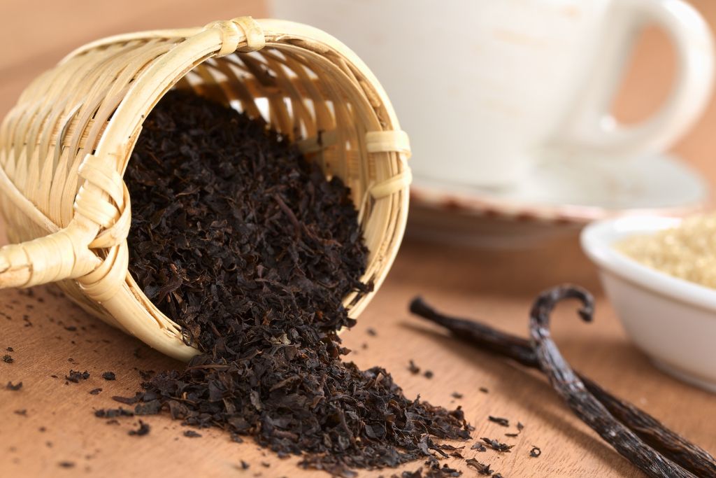 black tea herbs scattered on brown table