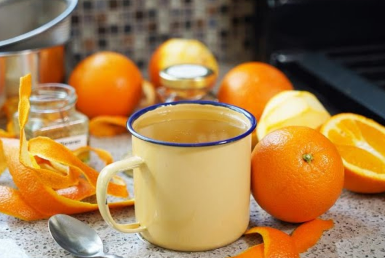 cup of hot orang peel tea with dried orange peel