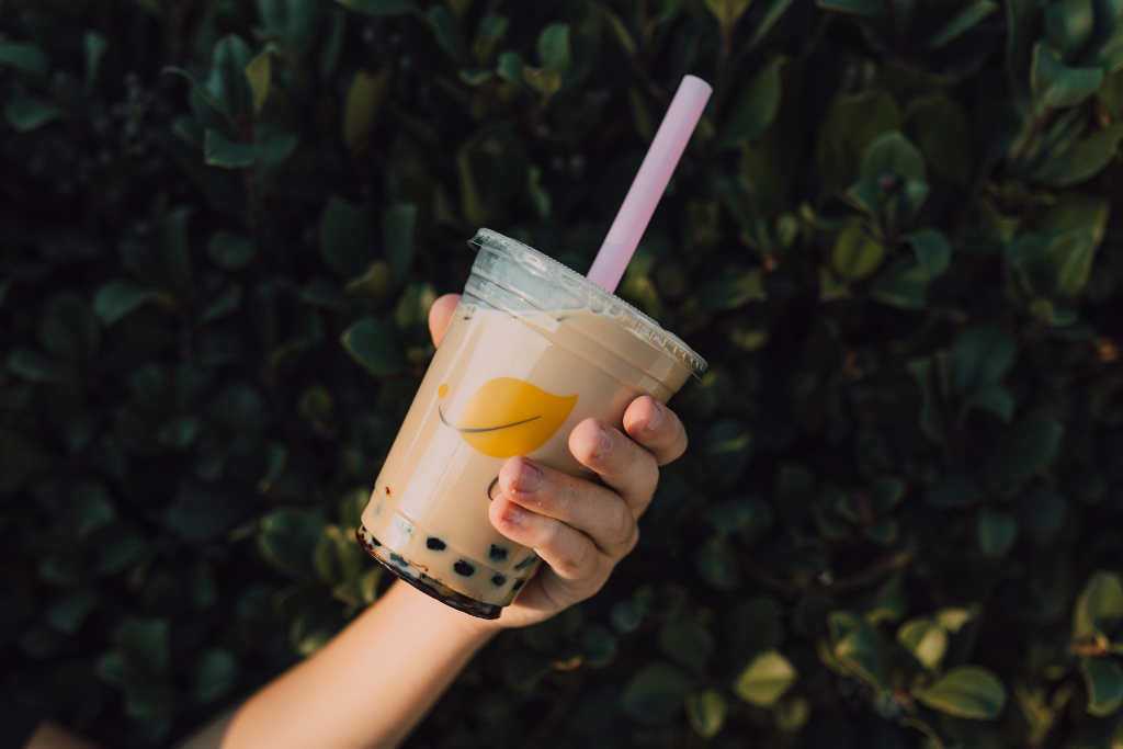 holding iced Classic Milk Tea