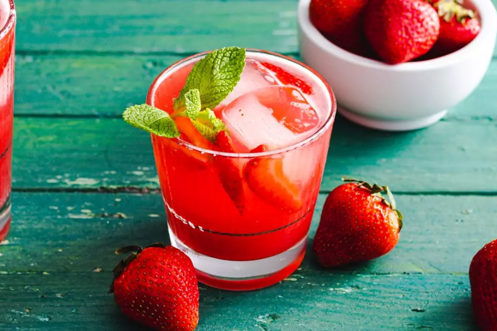 small glass of strawberry mint tea with strawberries 