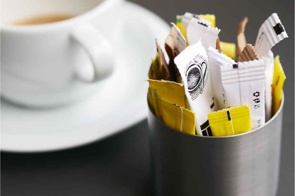 Sweeteners with tea as a background