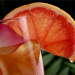 Grapefruit Green Tea on a glass with a sliced grapefruit on it