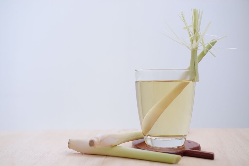 Lemongrass tea placed in a wooden coaster with lemongrass 